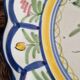 Large hand-painted French faience plate with floral decoration in folk art style.