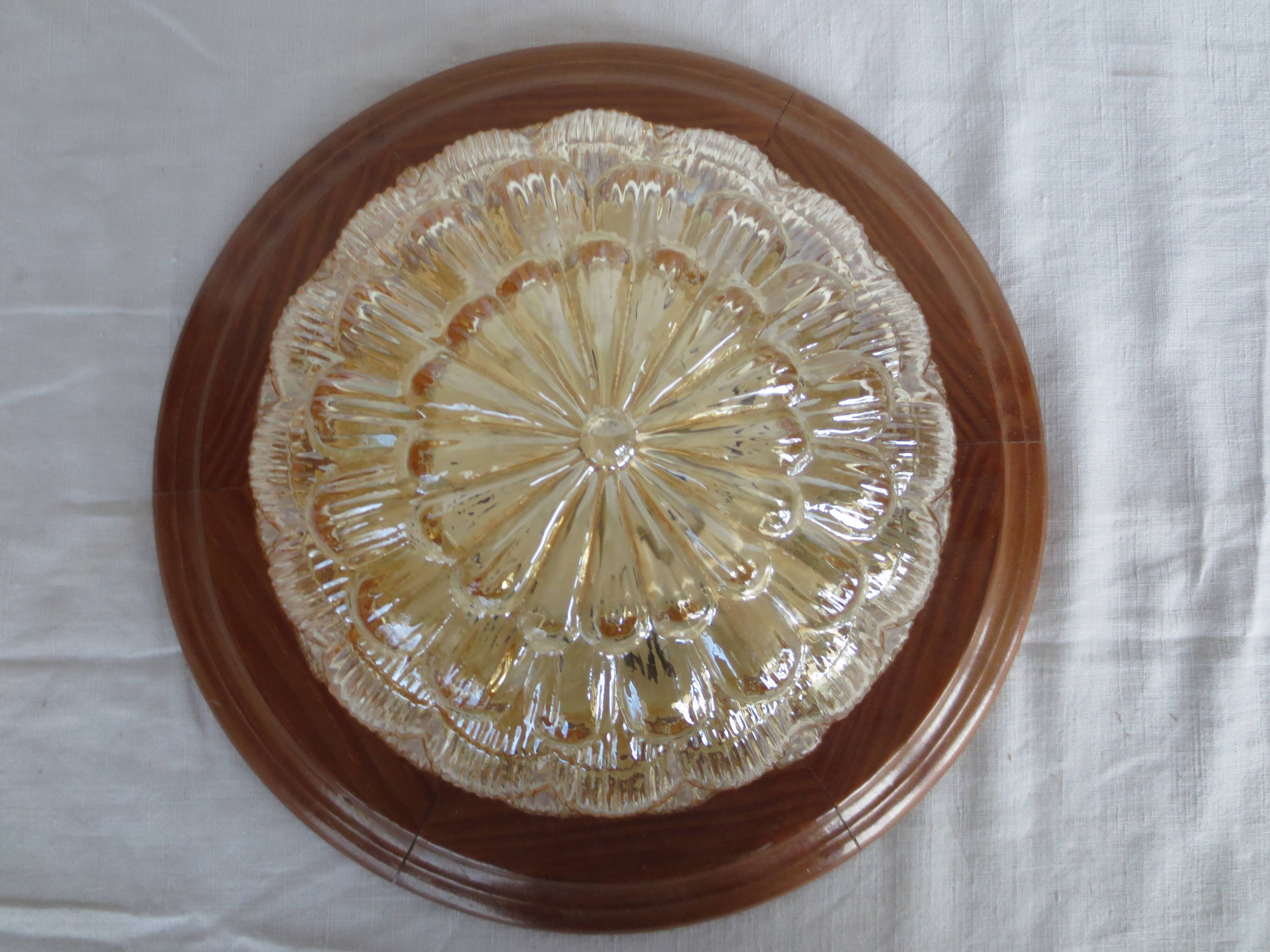 ceiling light with amber glass globe, on a round light wood base