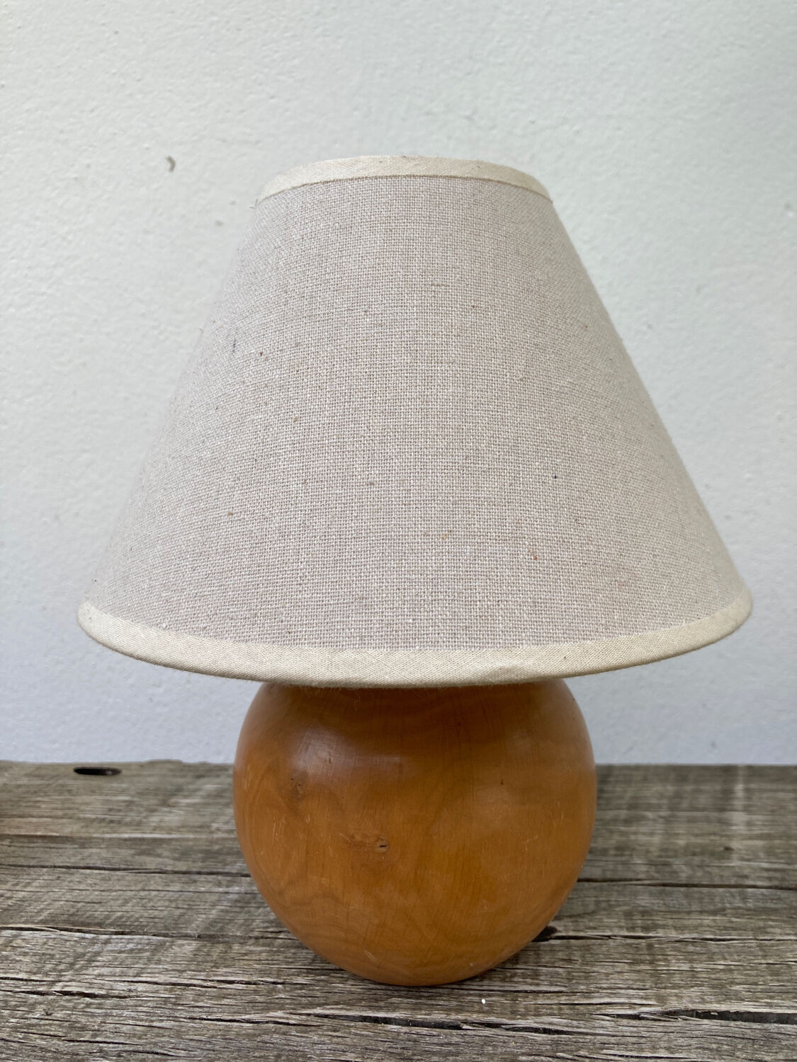 Wooden ball bedside lamp and beige lampshade
