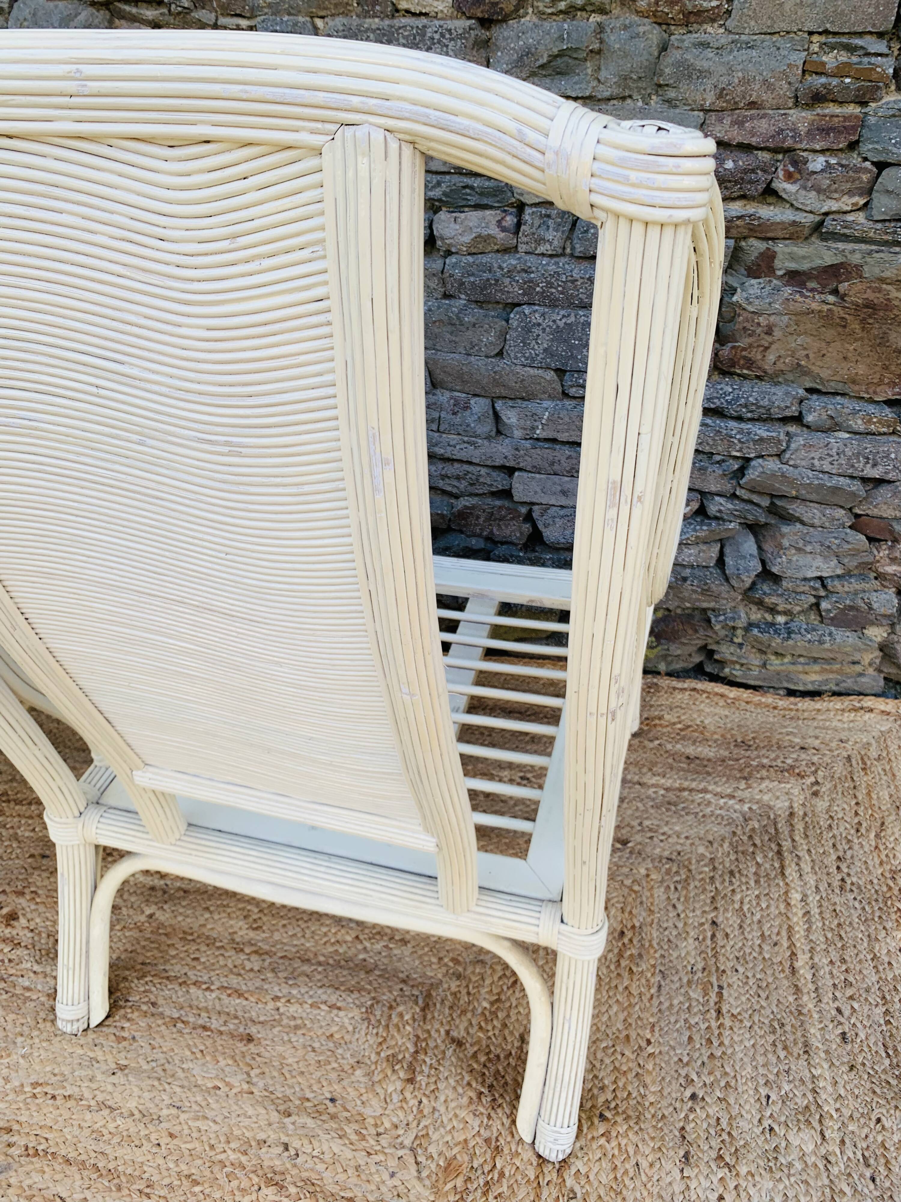 Pair of white rattan armchairs