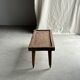 Brown Indonesian teak coffee table, with a border and cylindrical legs H40 L103.