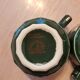 Green and gold coffee cups and sub-cups