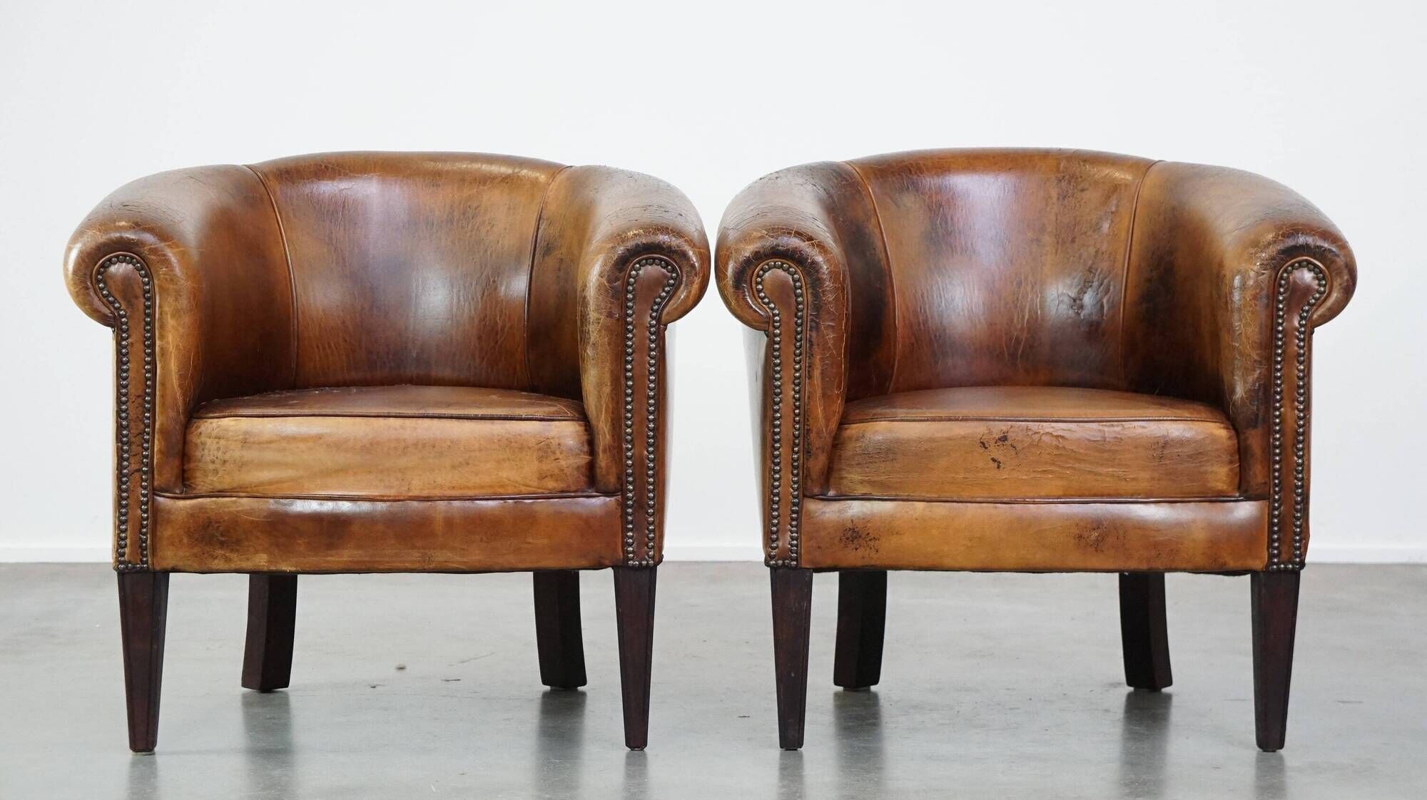 Set of 2 subtle, stately and sturdy club chairs made of sheepskin