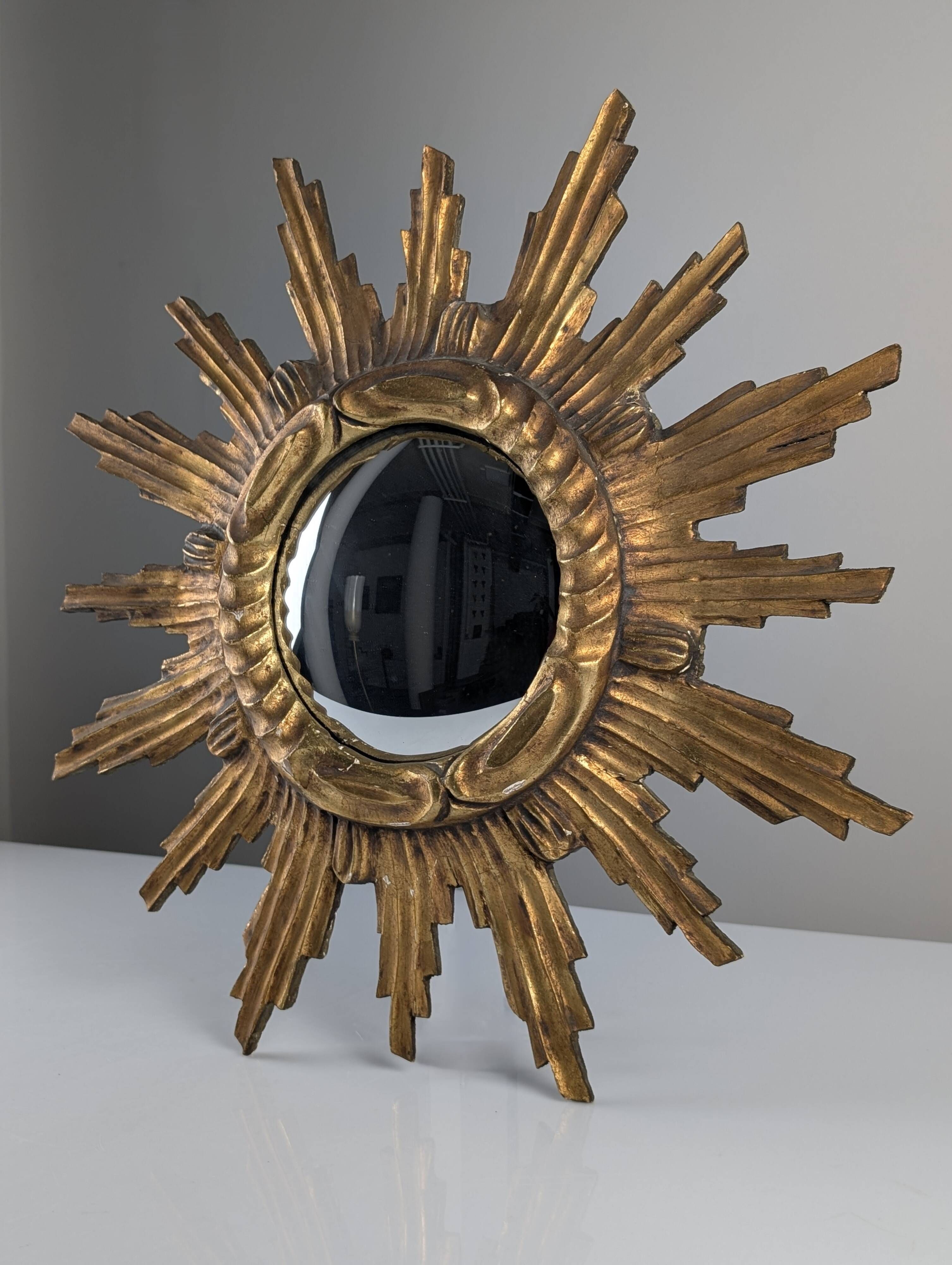Convex sunburst mirror in carved and gilded wood, 1950s