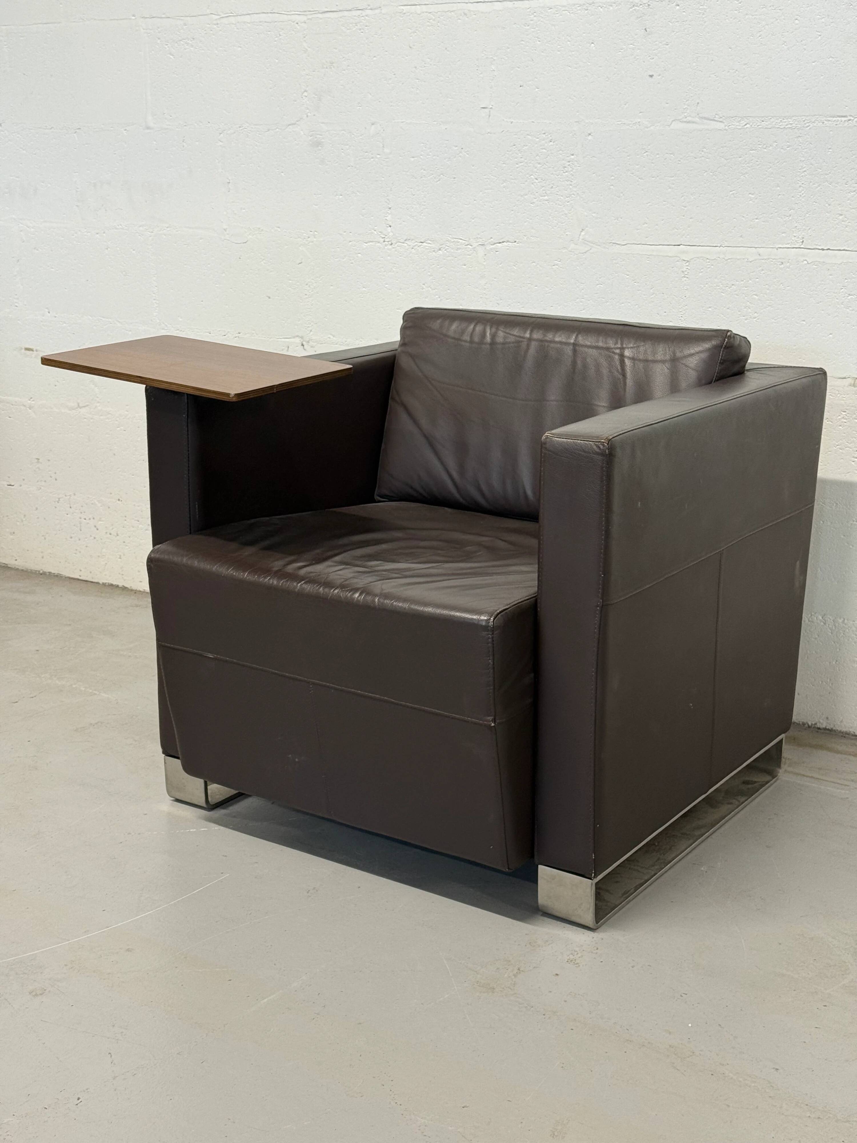 Vintage brown leather club armchair with a swivel side table.