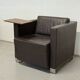 Vintage brown leather club armchair with a swivel side table.