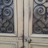 Porte d'entrée cintrée double en chêne, grilles et verre, XIXème