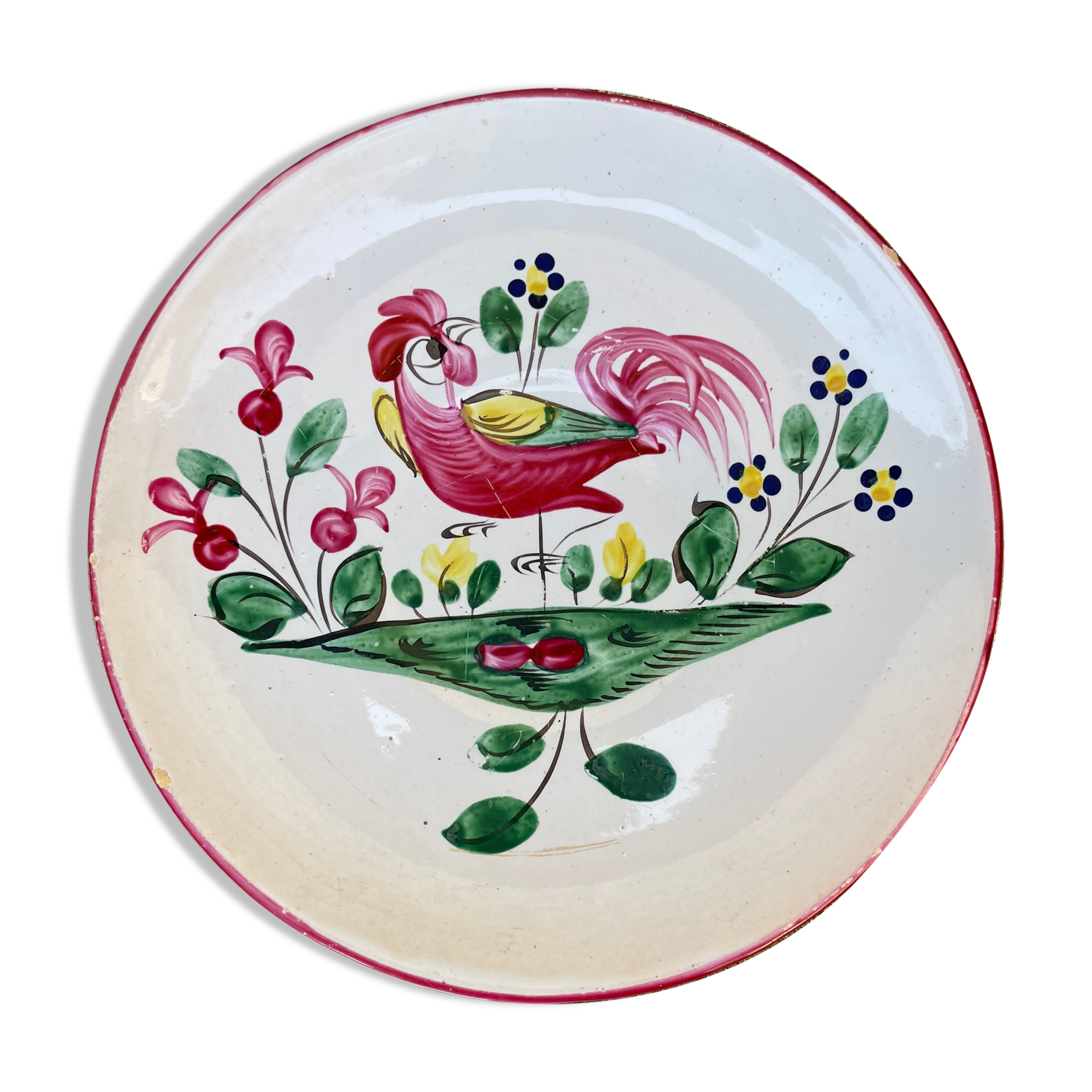 Antique plate with a flower and rooster pattern.