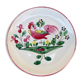 Antique plate with a flower and rooster pattern.