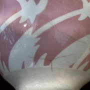 Old footed bowl in earthenware with pink decoration and defects.