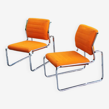 Pair of designer armchairs in orange fabrics and chrome tubes from the 70s