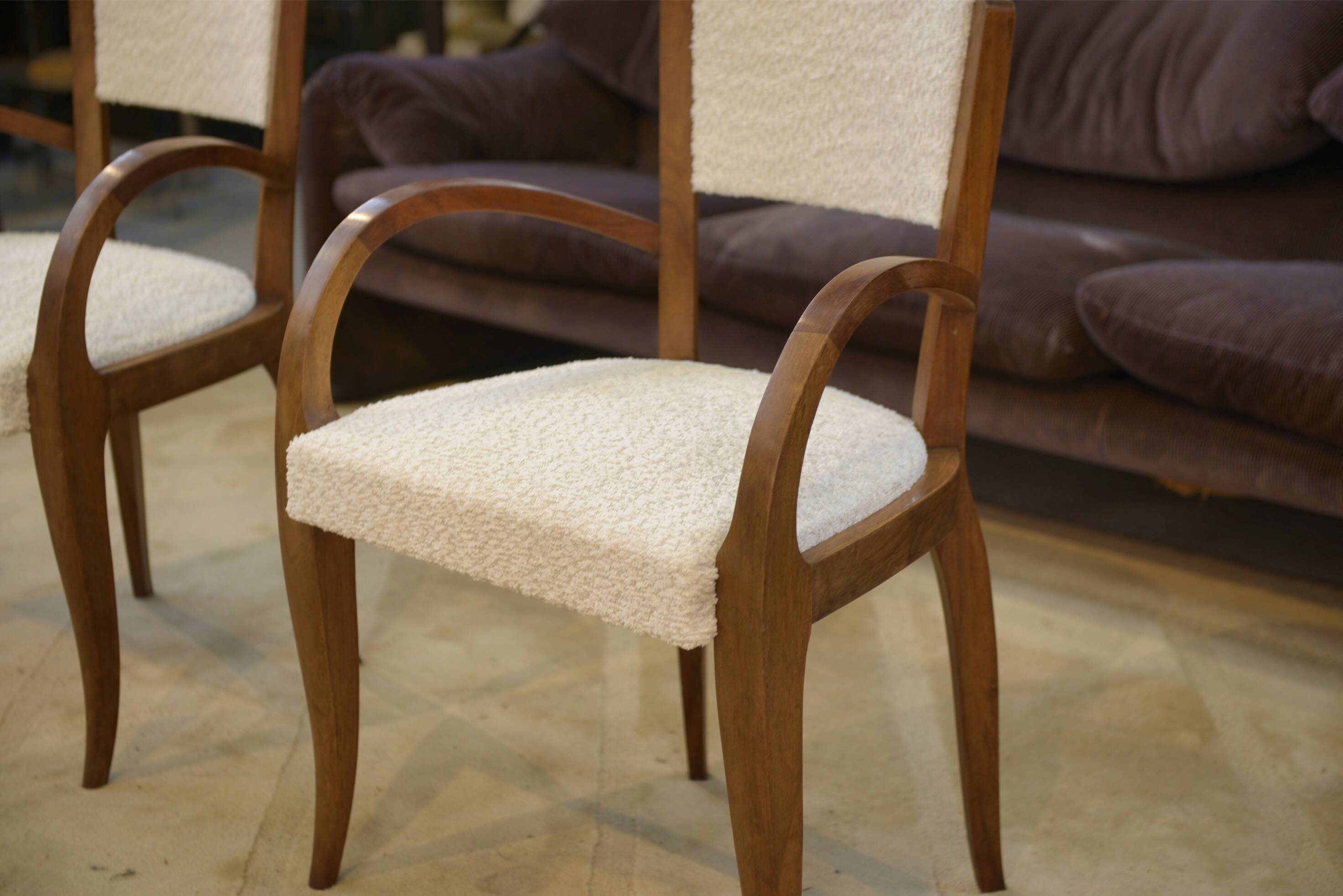 Pair of bridge armchairs in walnut and cream boucle fabric, early 20th century.