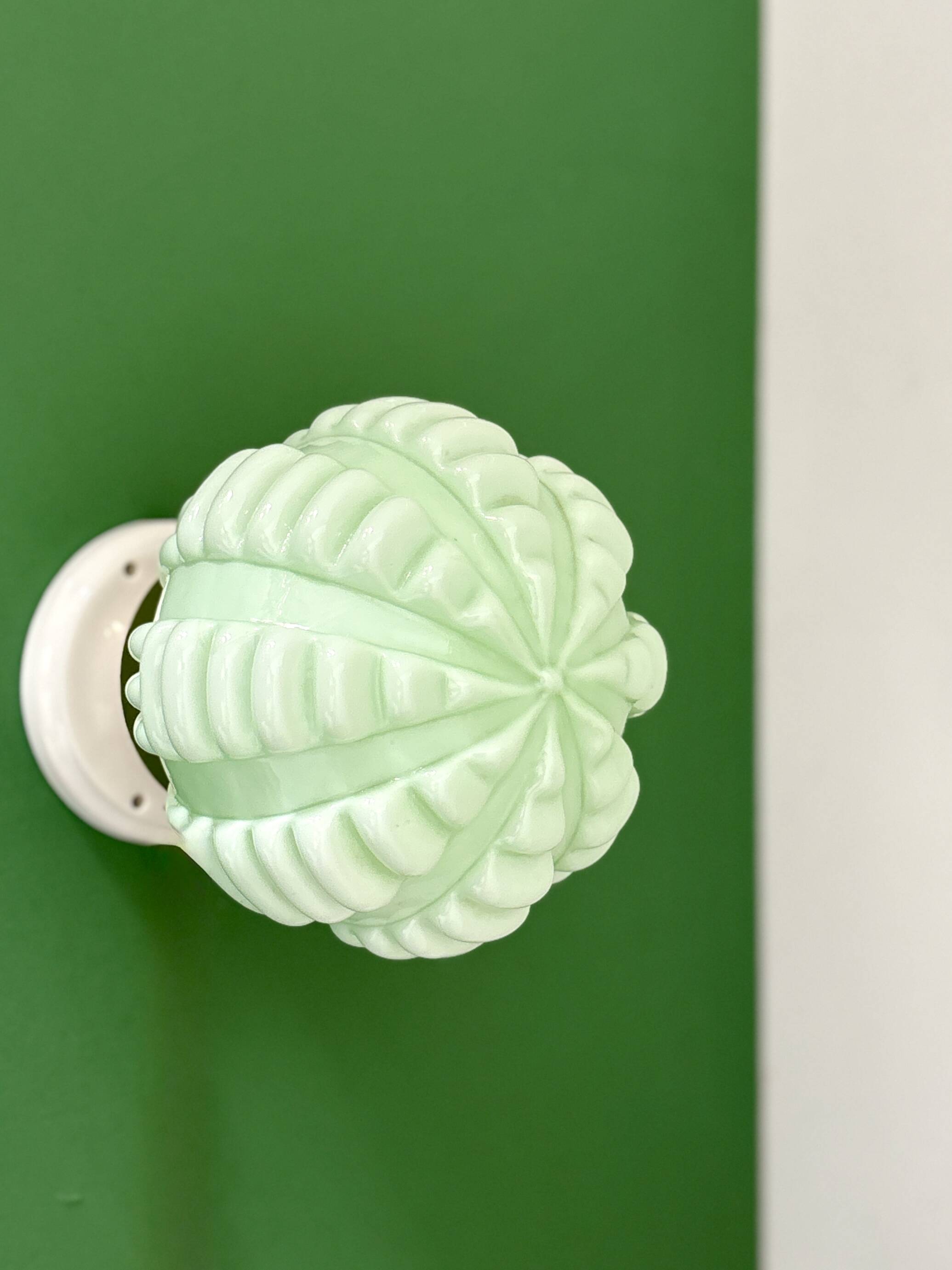 Vintage Art Deco globe wall light in pale green opaline.