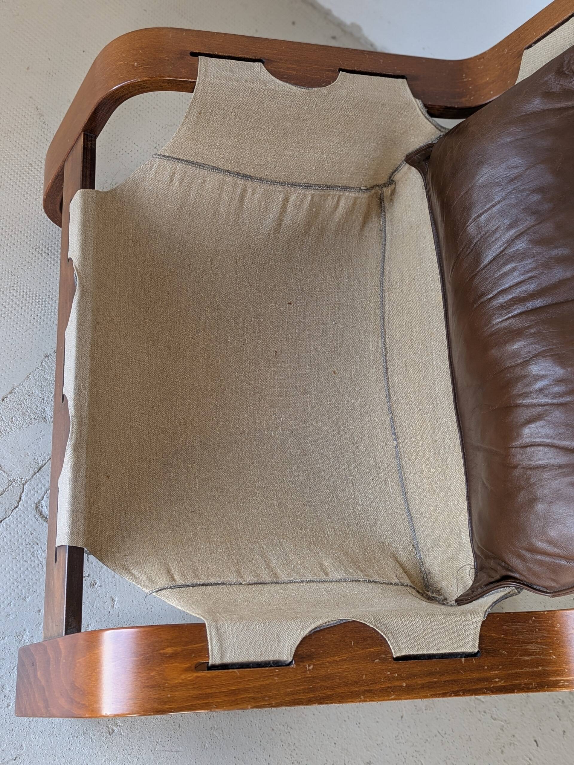 Leather and wood armchair, brutalist style.