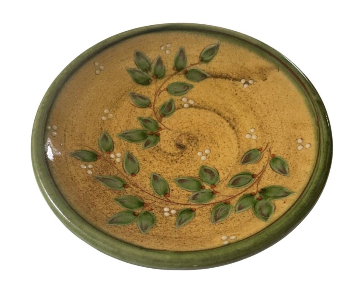 Decorative glazed terracotta plate with olive leaf pattern.