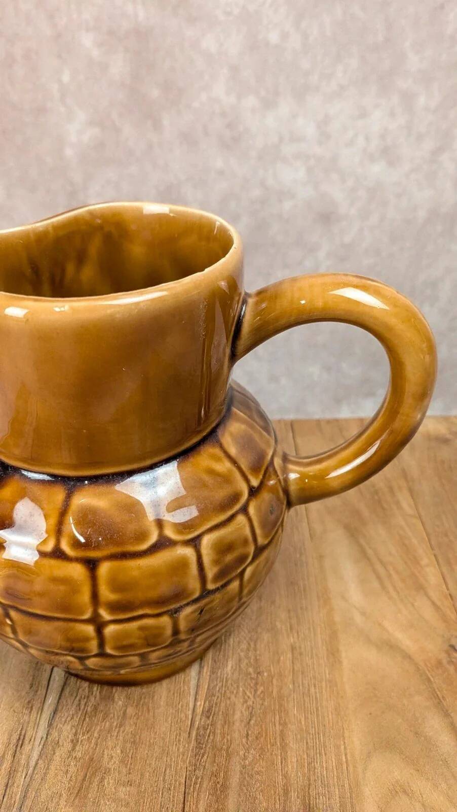 Vintage Sarreguemines pitcher with brown relief decoration.