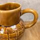 Vintage Sarreguemines pitcher with brown relief decoration.