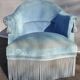 Blue velvet toad chair with fringes and pom poms