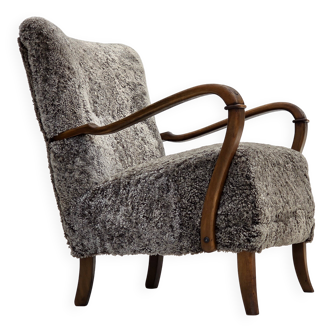1960s, reupholstered Danish armchair, New Zealand genuine sheepskin.