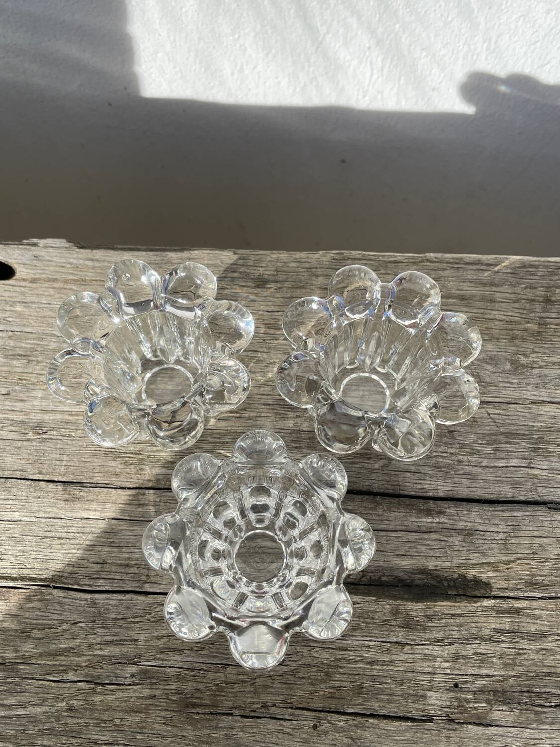 Trio of small, clear glass candle holders