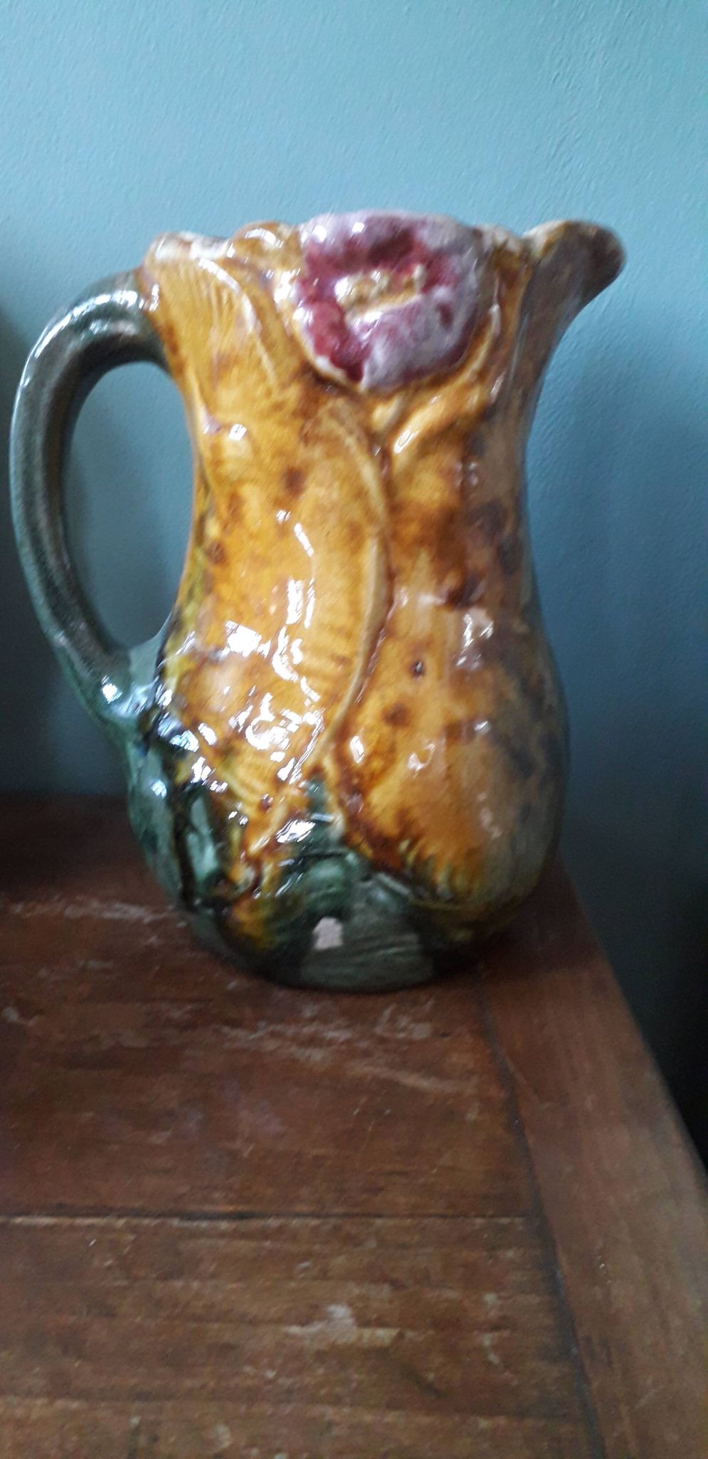 Vintage barbotine pitcher with floral decoration
