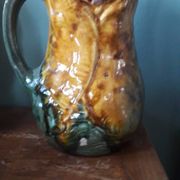 Vintage barbotine pitcher with floral decoration