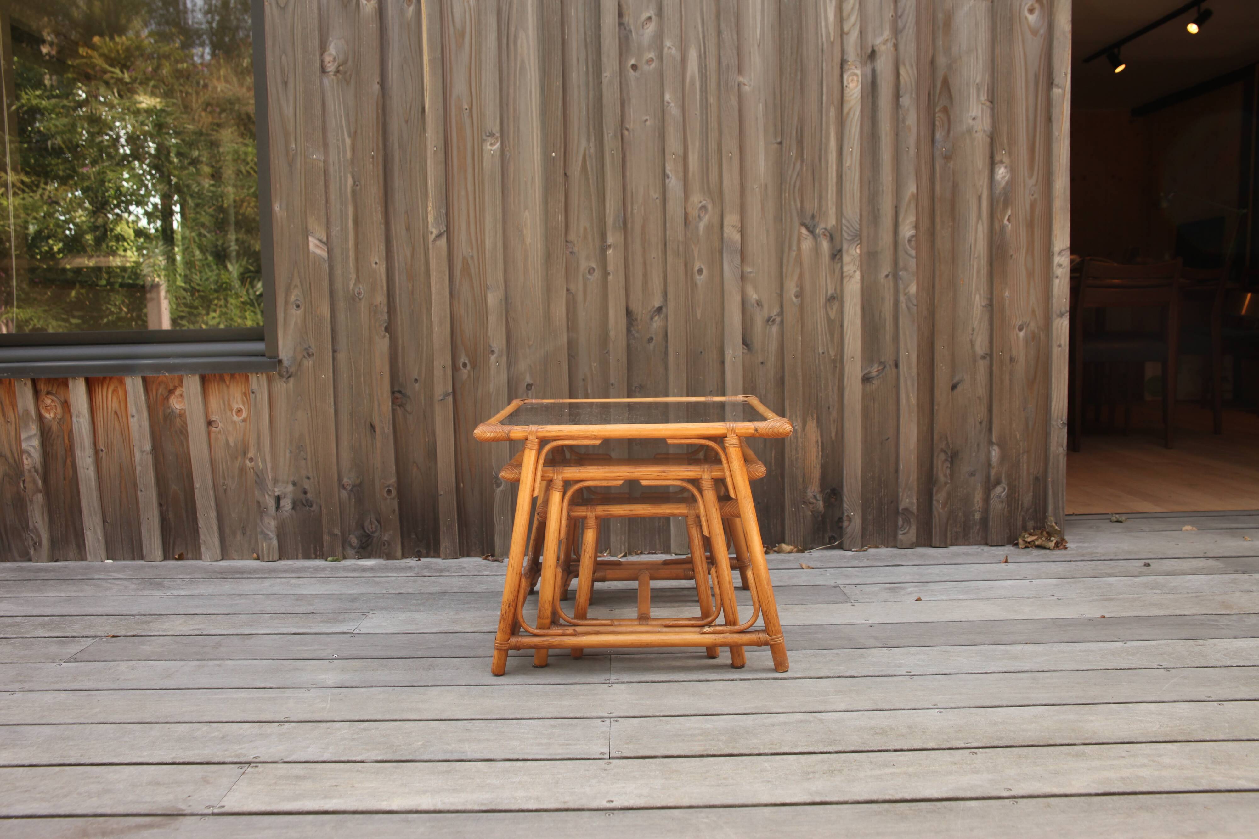 Nesting tables in rattan and glass