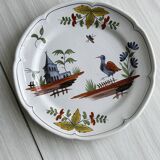 Hand-painted earthenware plate with landscape and bird decoration.
