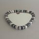 Small wall mirror, round triangle in black and white ceramic, 1950s, Germany.