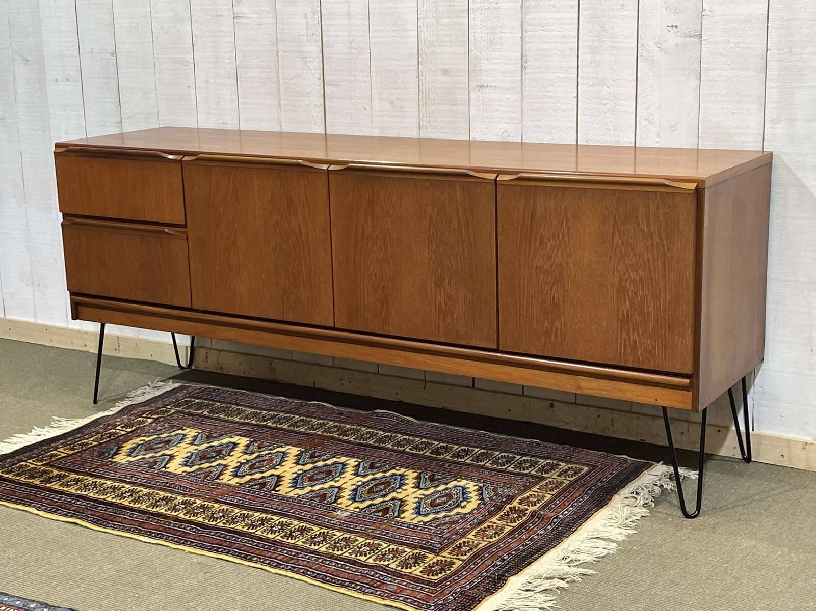 1970s English enfilade in teak with splayed legs.