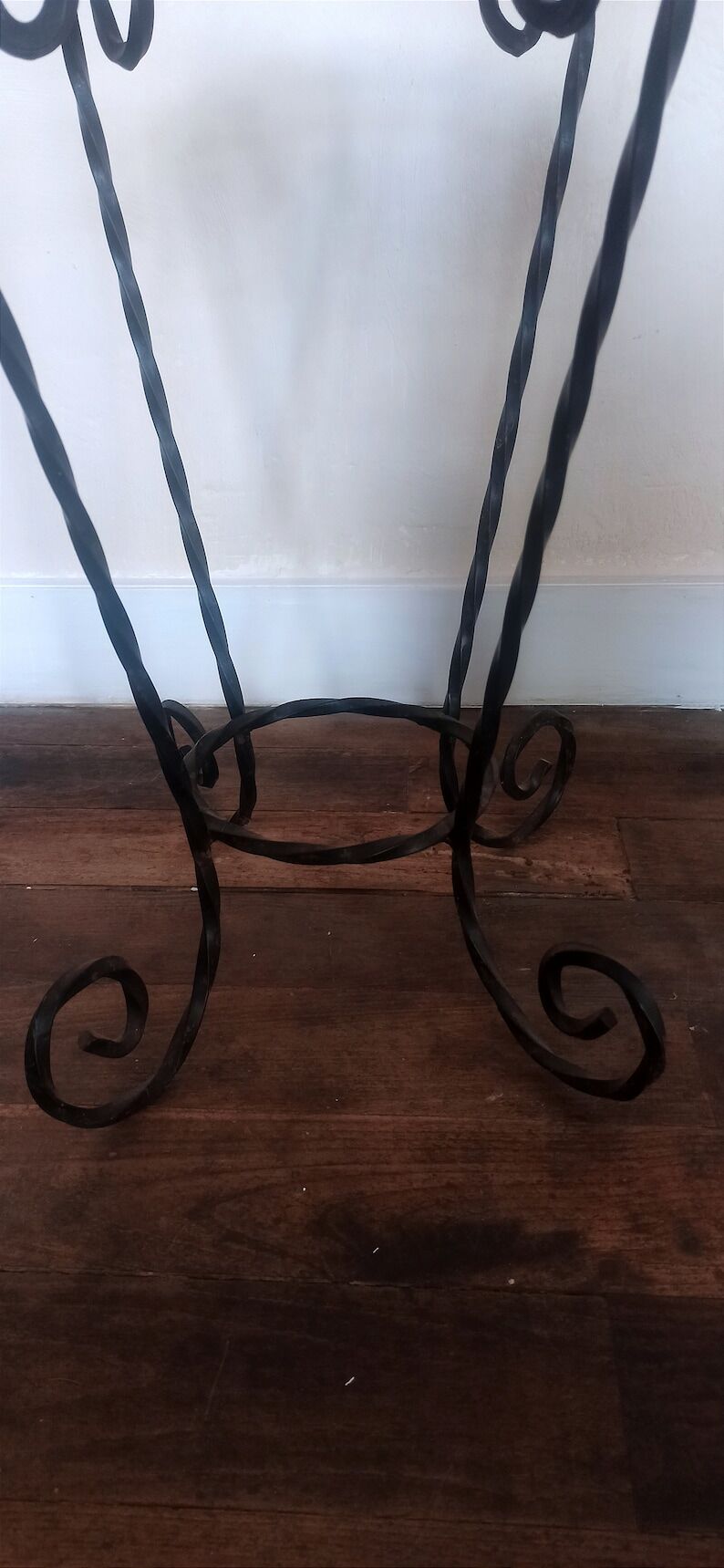 Black wrought iron support for plants