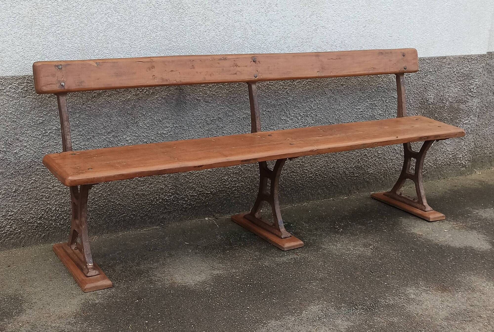 Old wooden bench with cast iron base