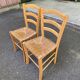 2 solid wood kitchen chairs with straw in a country style