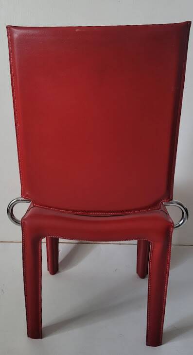 Red leather dining chairs by Arper