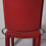 Red leather dining chairs by Arper