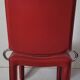 Red leather dining chairs by Arper