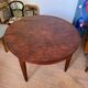 Oval extendable dining table in wood and walnut burl veneer.