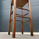 Old high bar stool in wood and straw