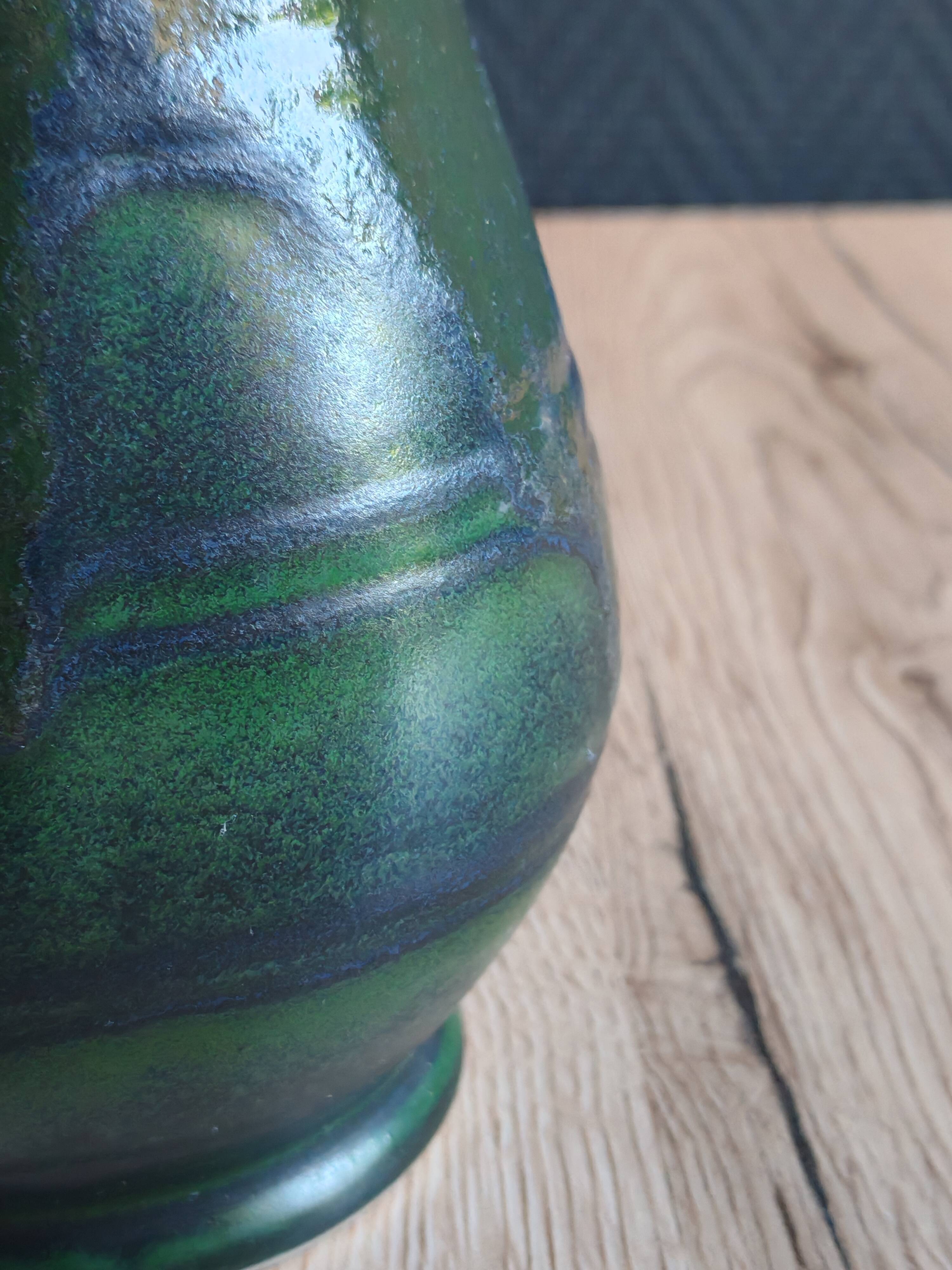 Vintage ceramic pitcher vase in glazed green and blue.