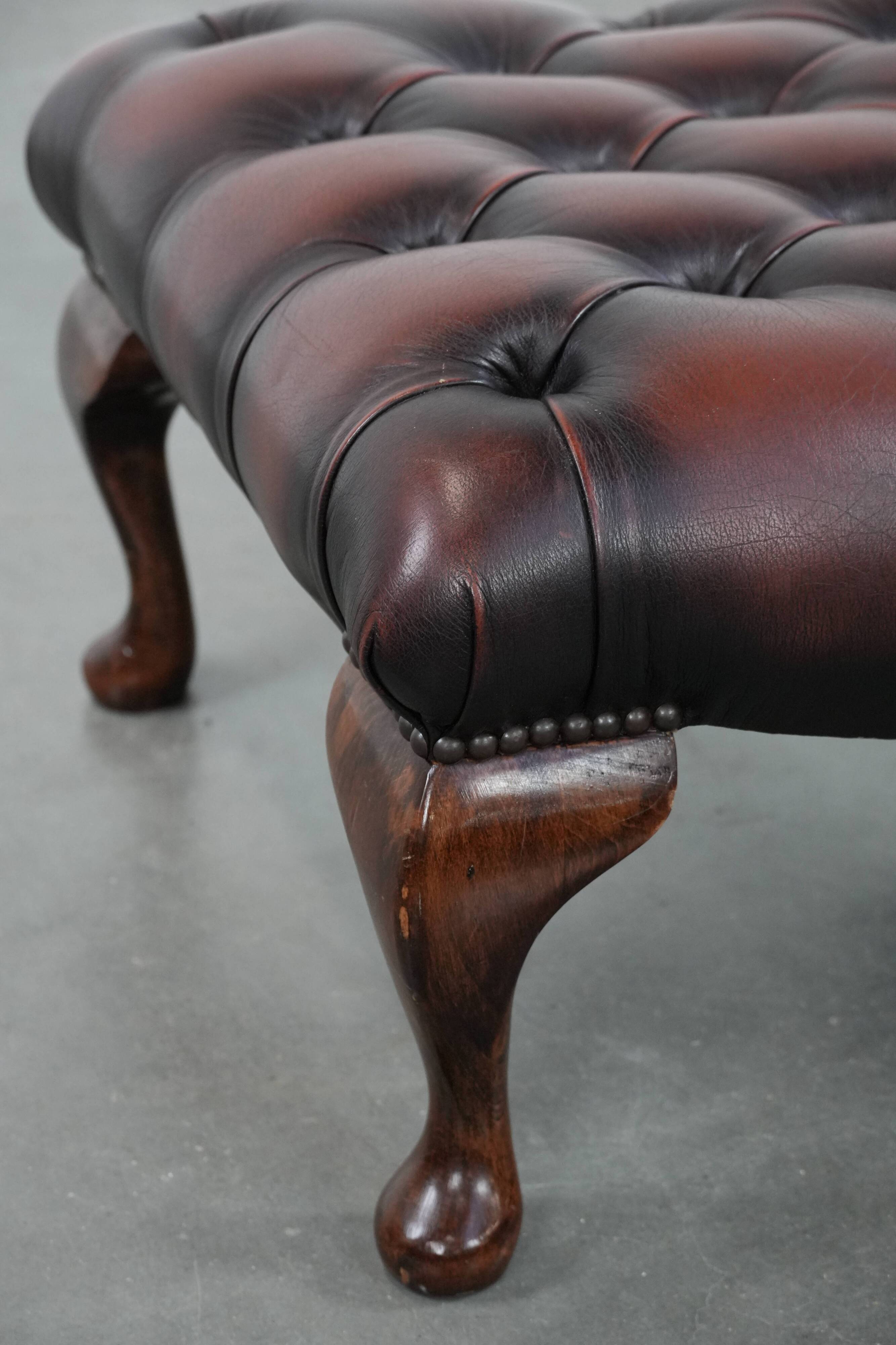 Dark brown chesterfield ottoman in cowhide leather