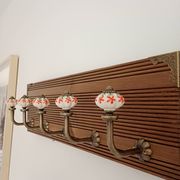 Vintage wall coat rack with 5 ceramic hooks featuring floral patterns - wood