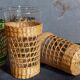 Four long drink glasses in vintage woven rattan cases