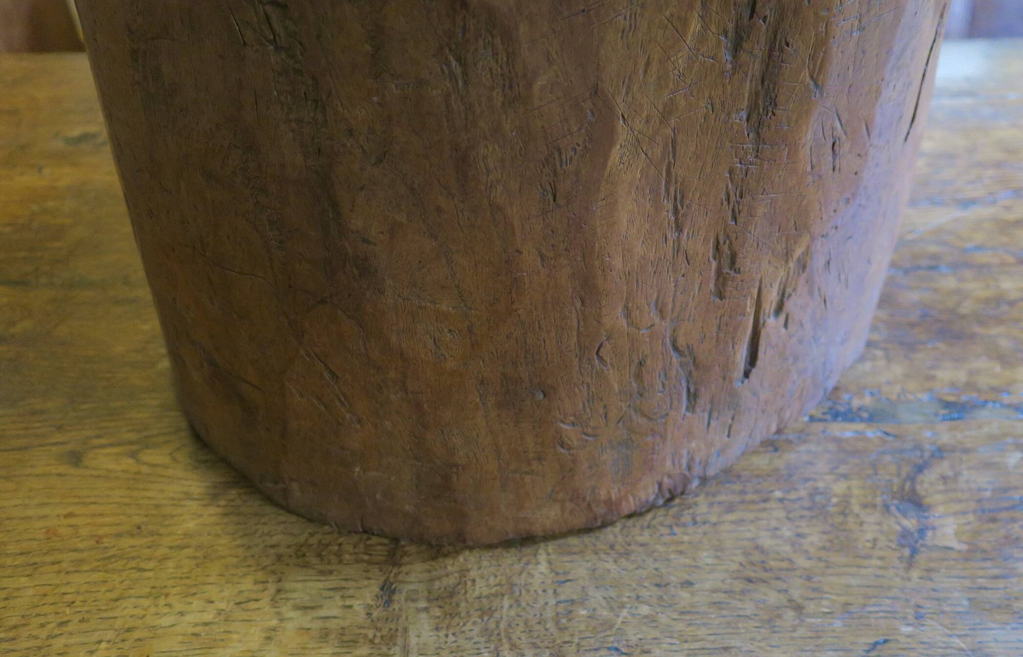 Antique hand carved mortar coffee table with circular glass top