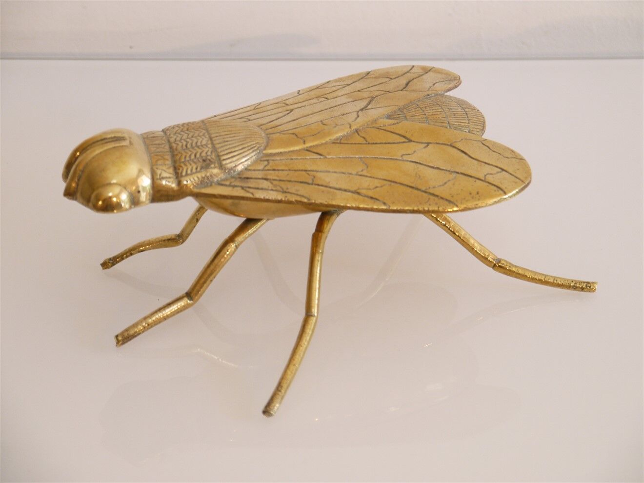 Empty vintage pocket in the shape of a brass insect