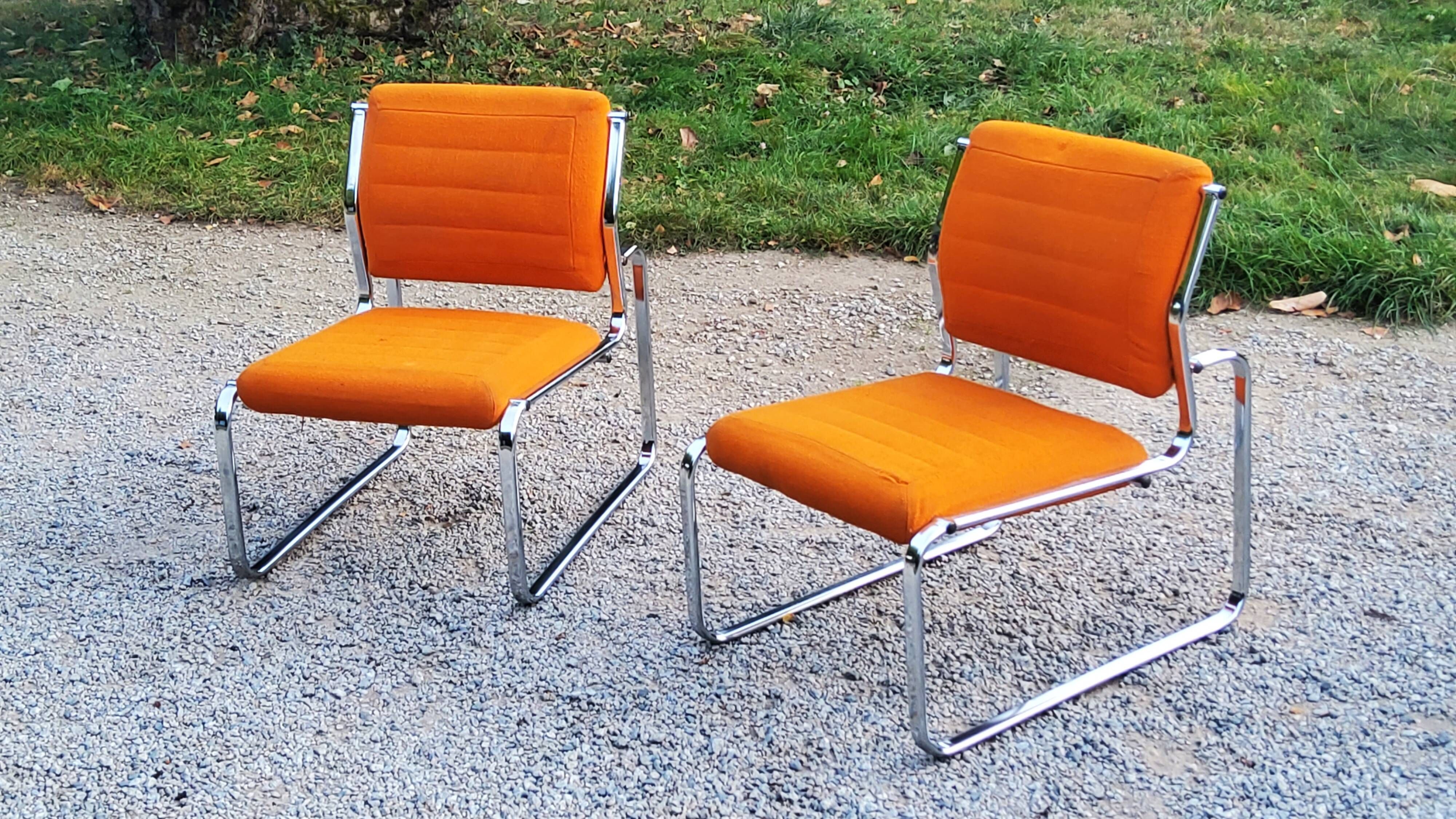 Pair of designer armchairs in orange fabrics and chrome tubes from the 70s