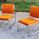 Pair of designer armchairs in orange fabrics and chrome tubes from the 70s
