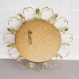 Round mirror on a brass frame with scrolls