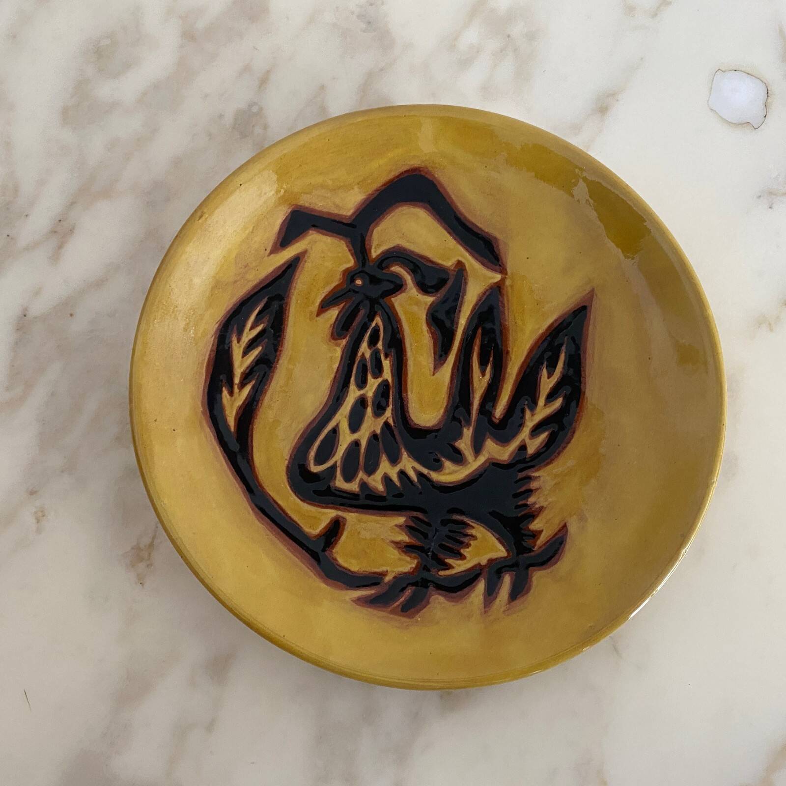 Terracotta plate by Jean Lurçat decorated with a rooster on a yellow background