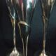 Lot of 12 silver metal flutes on brass stand
