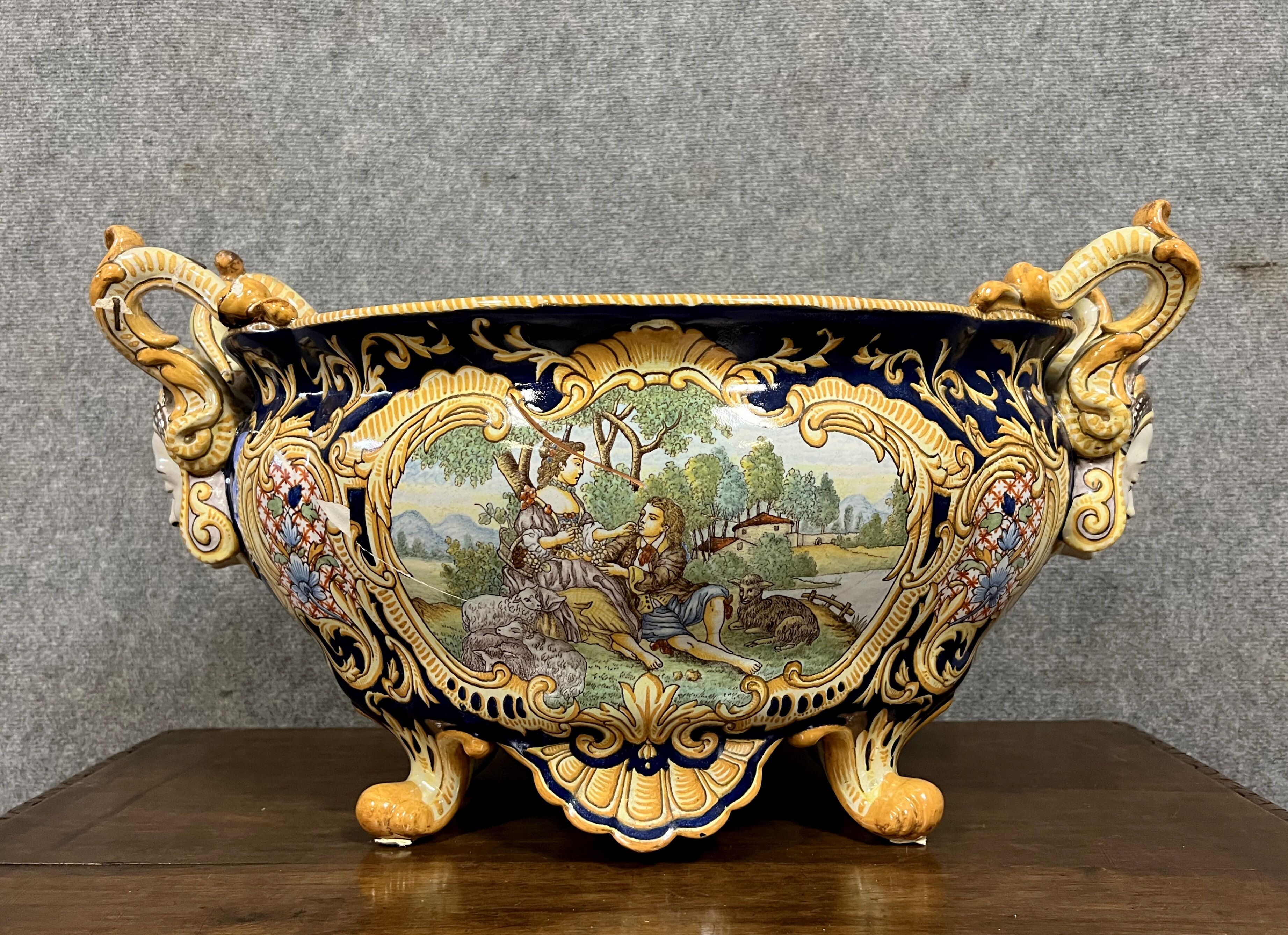 Earthenware planter with polychrome enamelled decoration on a blue background